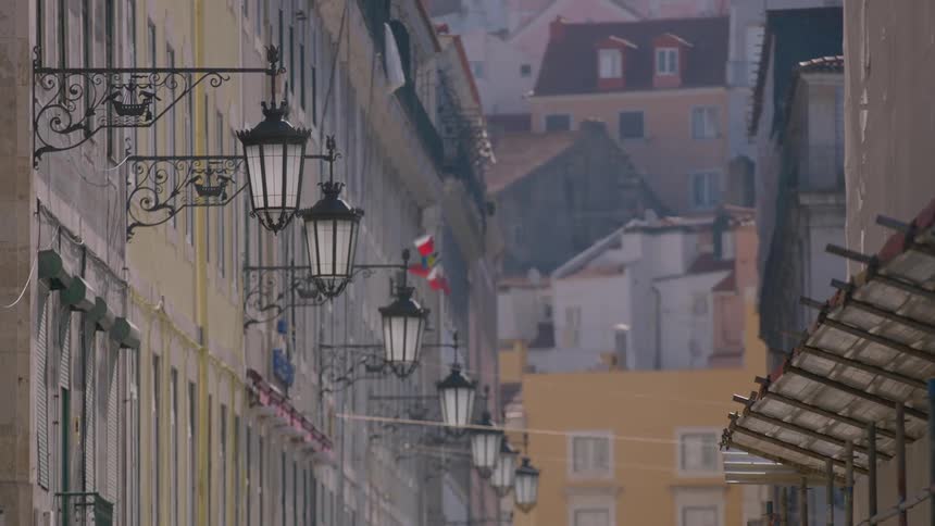 Lanterns hang from the side of a city building