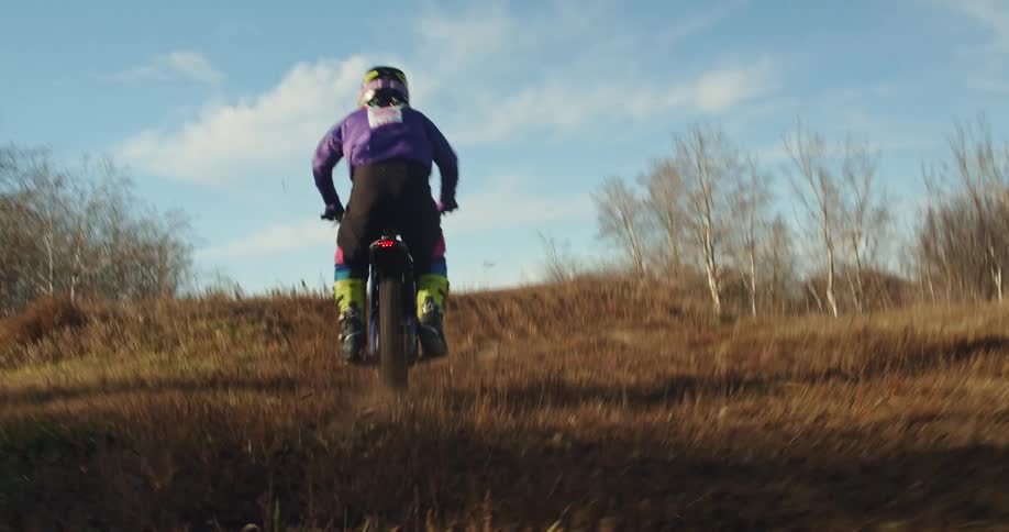 A man does a jump on his dirt bike