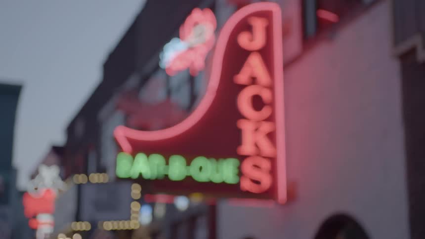 A blurry image of a neon sign outside of a restaurant