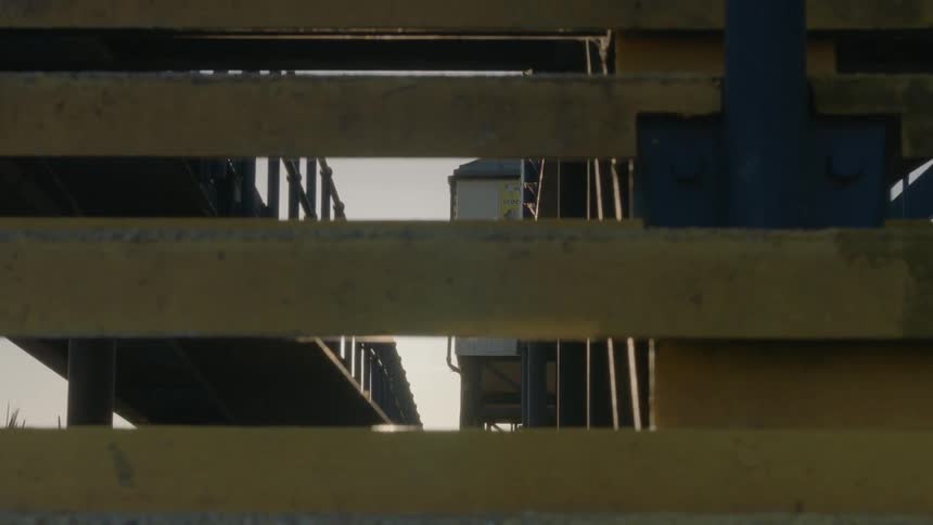 Close up of a staircase looking through the steps with sun shining