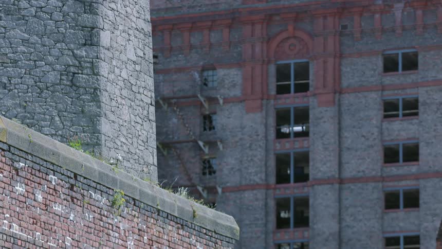 The tall buildings has many stories with windows