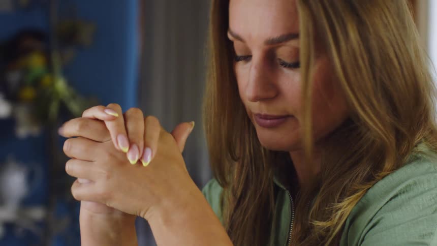 Blonde woman running her hand over her face