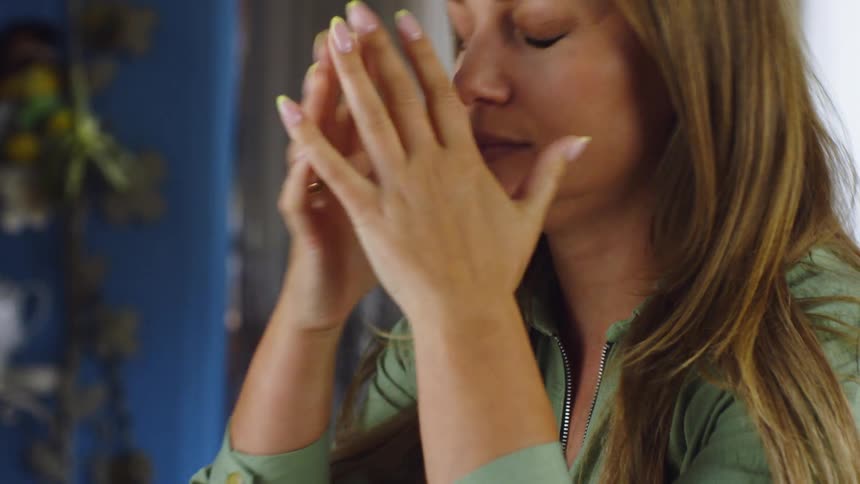 Woman sitting with her hand on her face