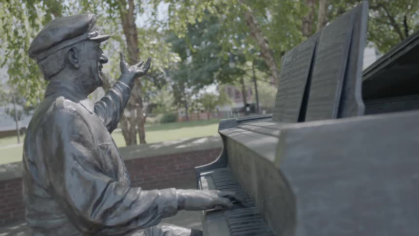 Statue of a man playing a piano