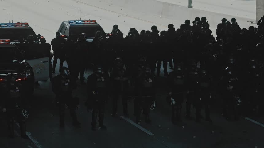 Police troop on a highway during the day