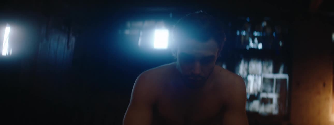 Shirtless man sitting indoors