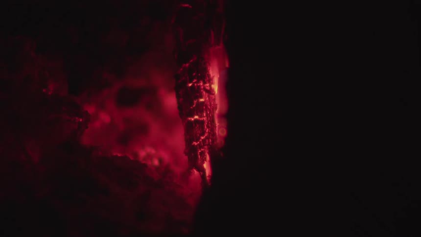 The wood is slowly burning at night