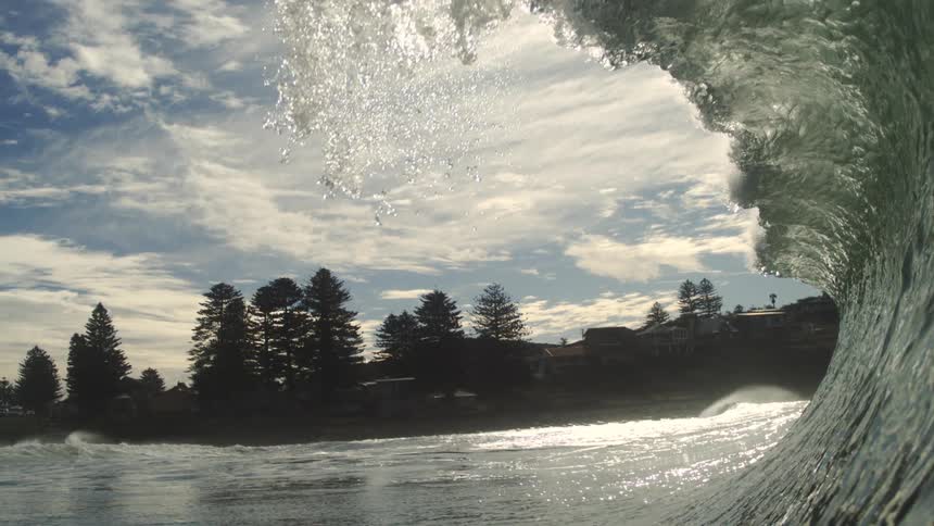 A big wave breaking in the sea with a view from inside it