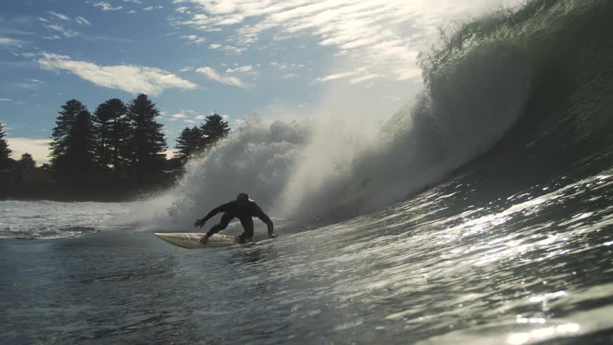The surfer rides the wave all the way