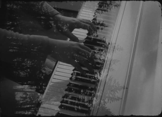 A woman is playing the piano with a superimposed image of a tree showing