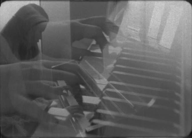 A girl is playing the piano at home