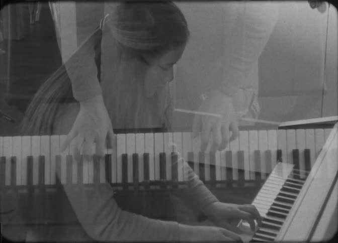 Young woman playing piano