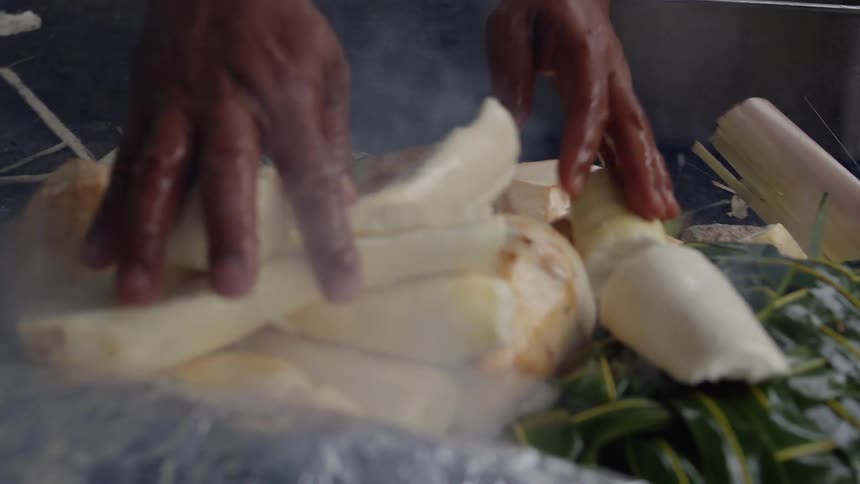 A person cooking pieces of potatoes
