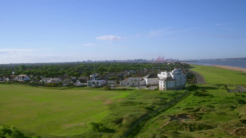 Houses line this green shore on a sunny day