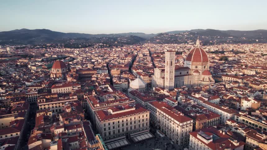 Panorama of a classic city with a church in the spotlight and mountains on the horizon