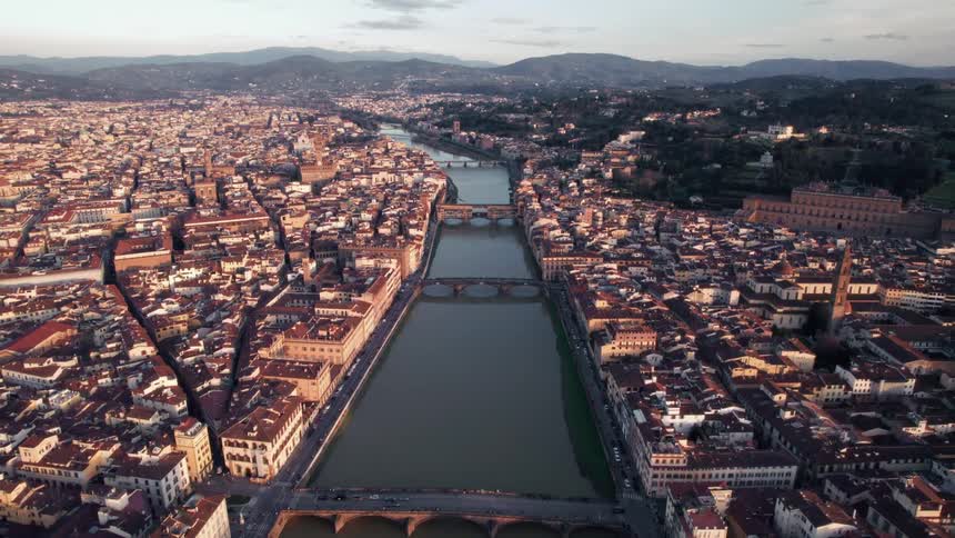 Aerial view of a european city at sunset divided by a river with connecting bridges