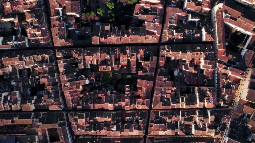 Aerial view of a residential neighborhood in the city with buildings closely packed near each other at midday