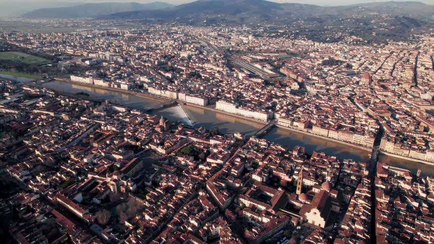 An aerial view of a large city split by a canal