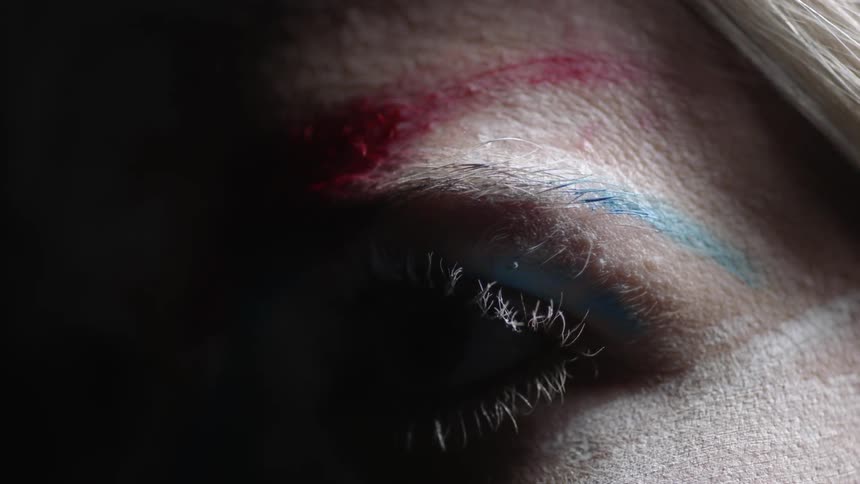 A person's face is slowly lit up