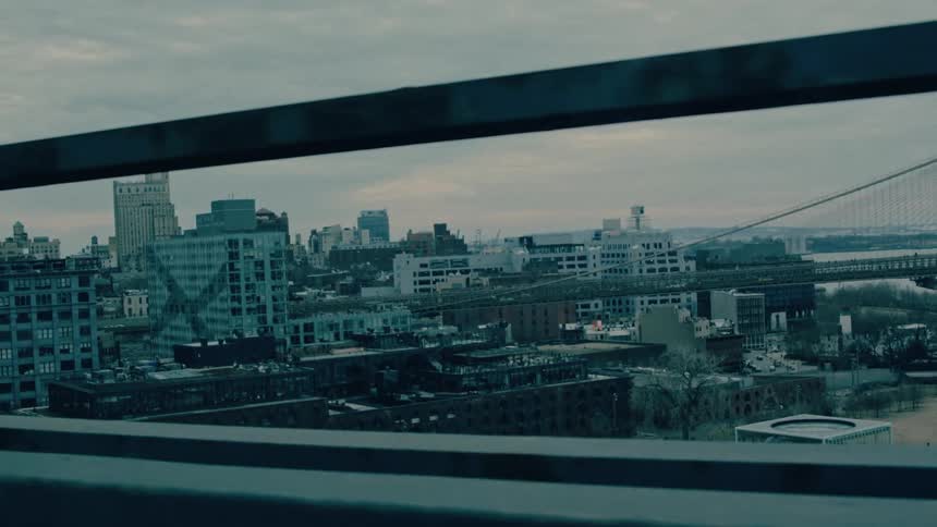 Driving on a bridge into a big city