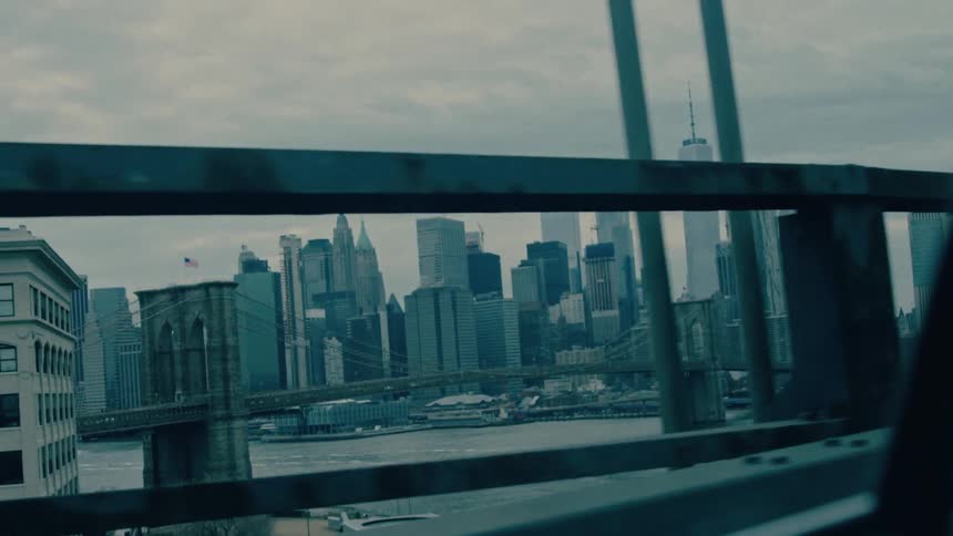 Driving on a bridge and seeing a city
