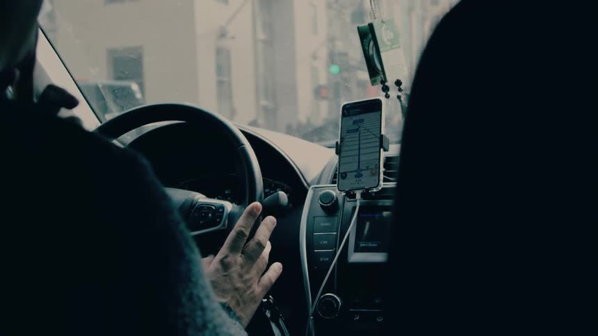 A man is driving in the city