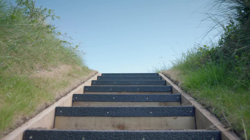 Steps lead up towards a clear sky