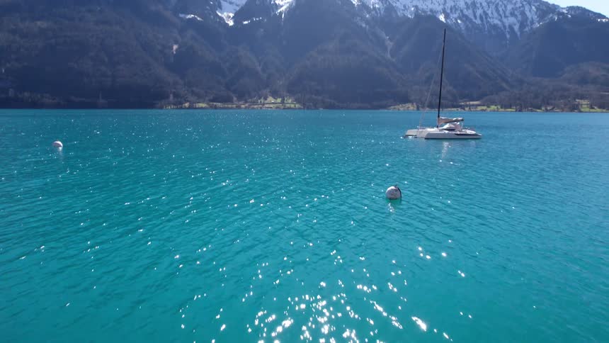 The water in the lake is blue by the mountain