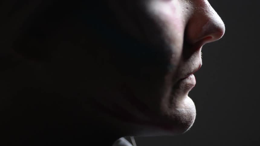 Light shines on a man's face