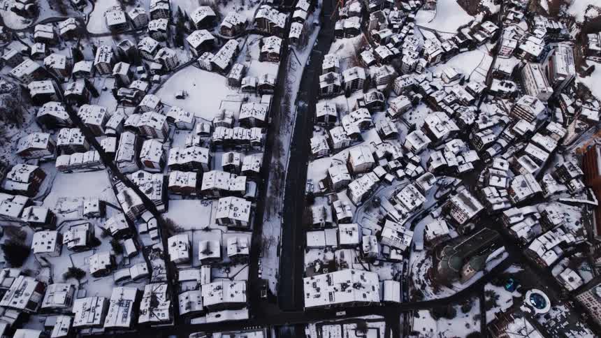 Picturesque village in the middle of mountains and covered in snow