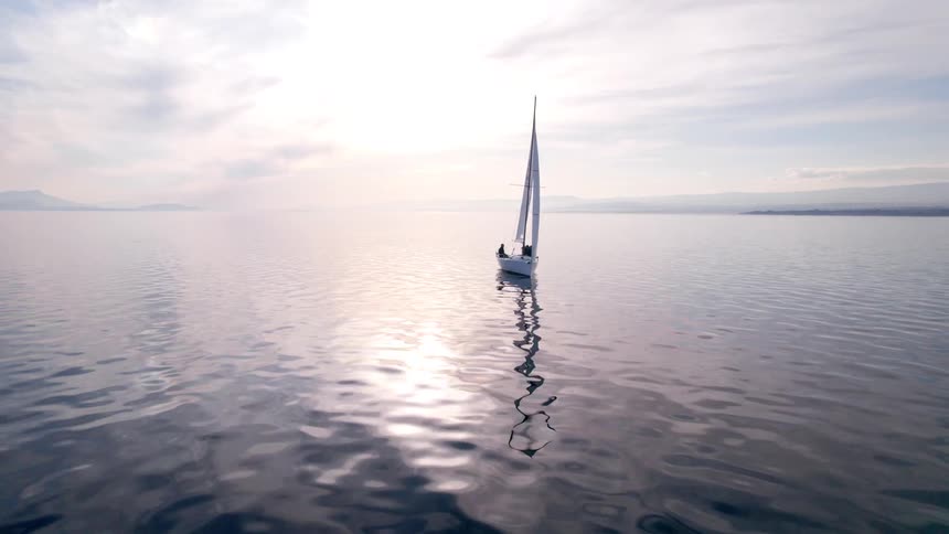 Sun is shining on the traveling sailboat