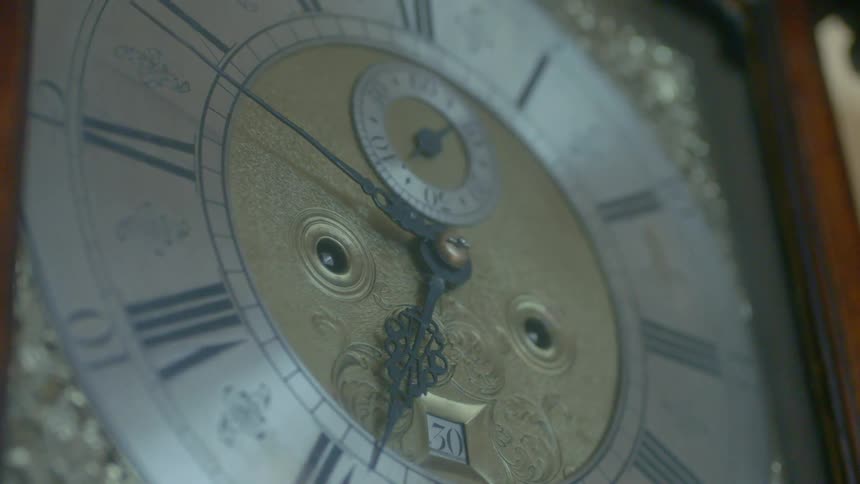 A clock has a metal dial