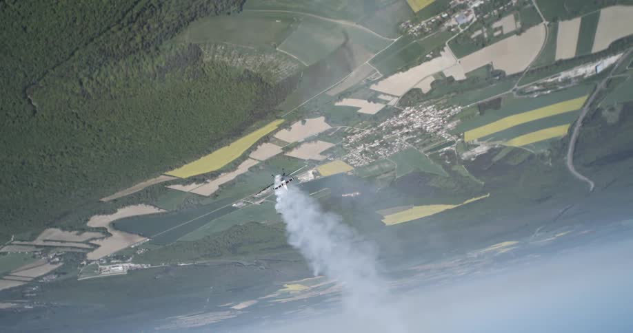 Singleengine aircraft releasing smoke and performing maneuvers