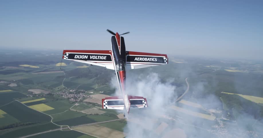 A biplane flies high in the sky