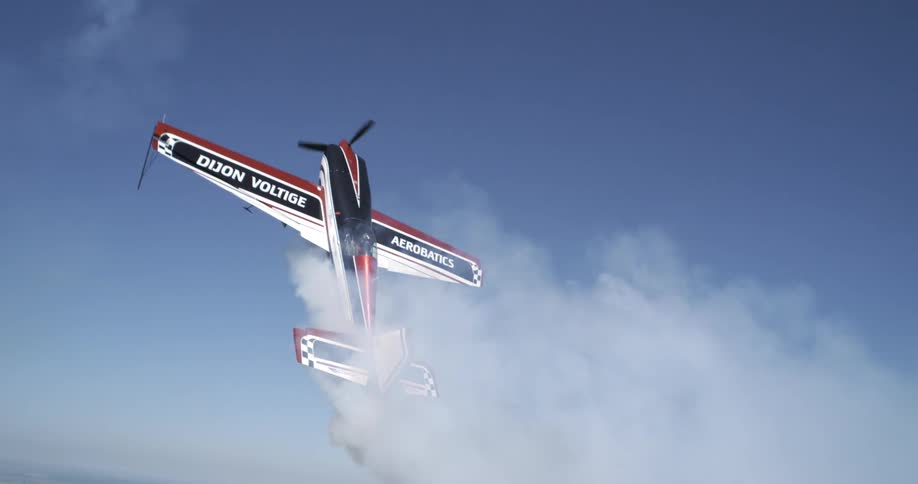 A smoking plane falls out of the sky in slow motion
