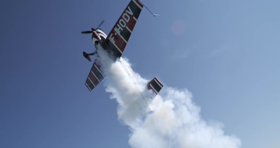 A biplane flies high in the sky