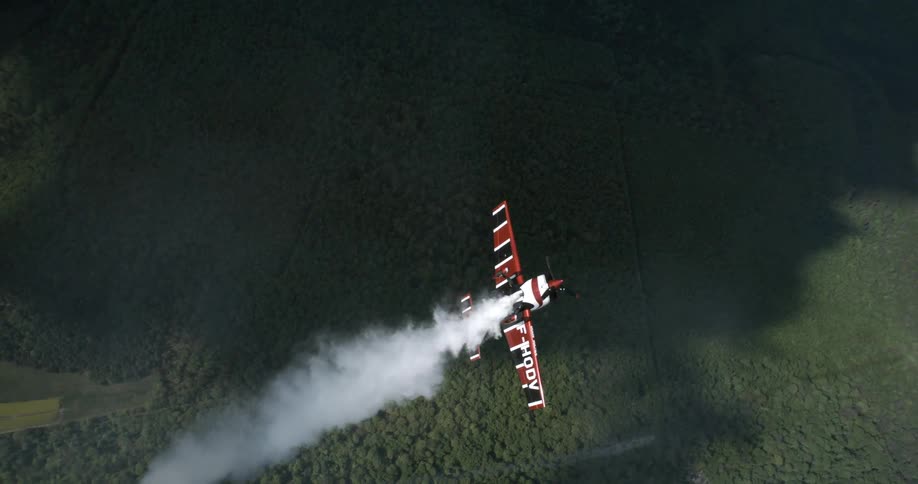 Aerial view of a singleengine aircraft flying over a natural area