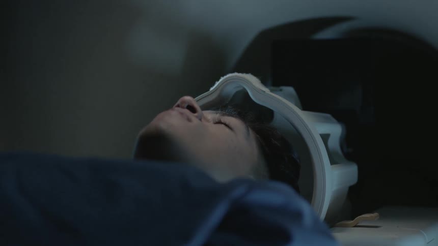A man lies on a table in an mri machine