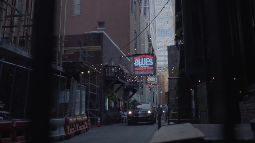 Vehicle parked outside a bar in an alleyway