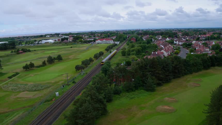 A train travels along the tracks near this town