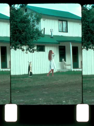 The woman swings a golf club in the yard