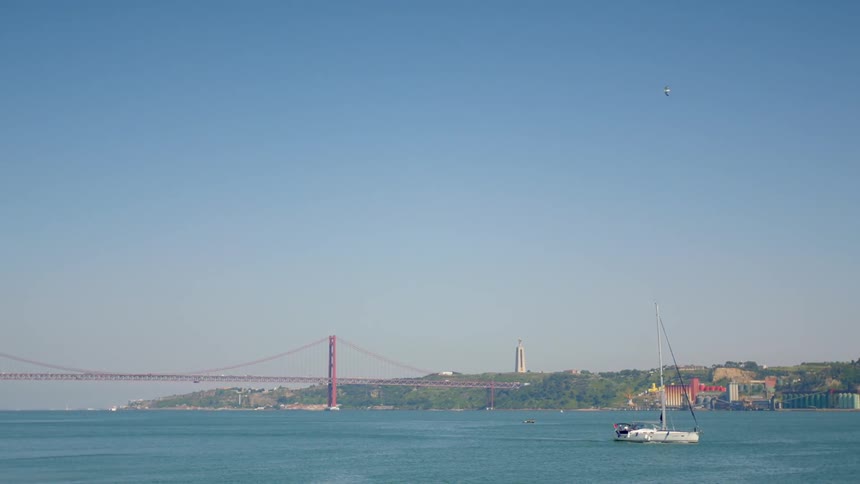 A small boat travels across calm water on a clear day
