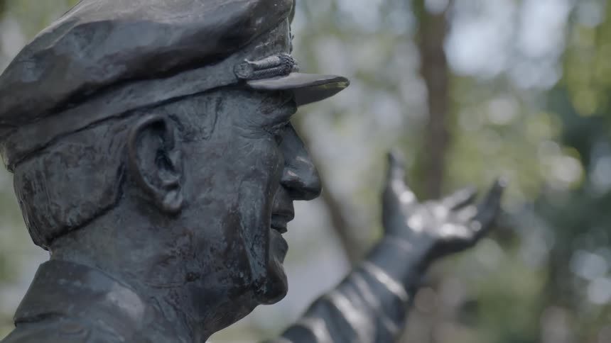 A statue of a man with his hand held up