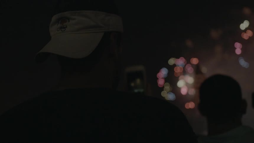People watching fireworks at night