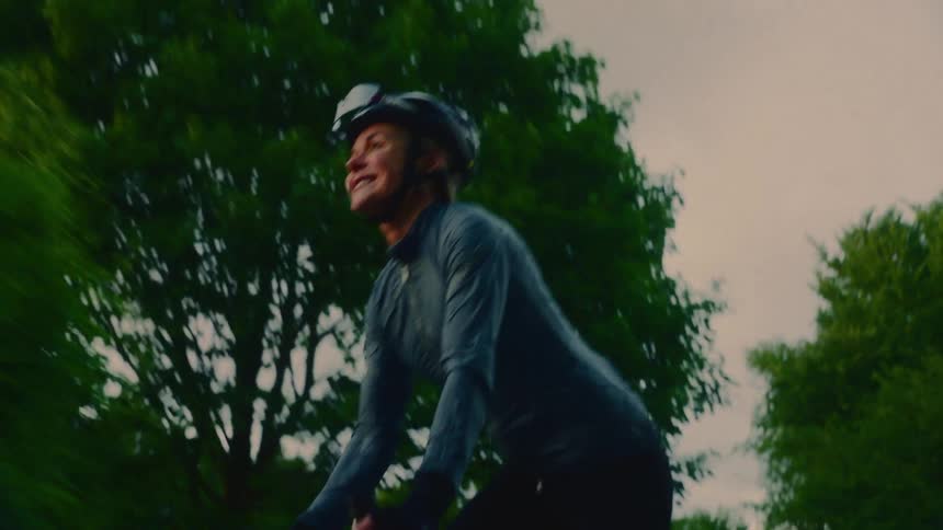 Happy woman cycling outdoors