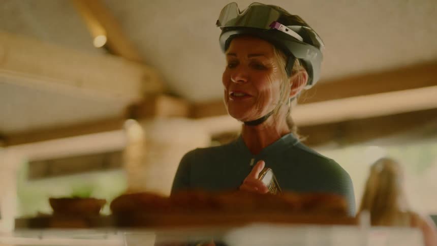 Woman wearing a helmet in a commercial establishment choosing a product