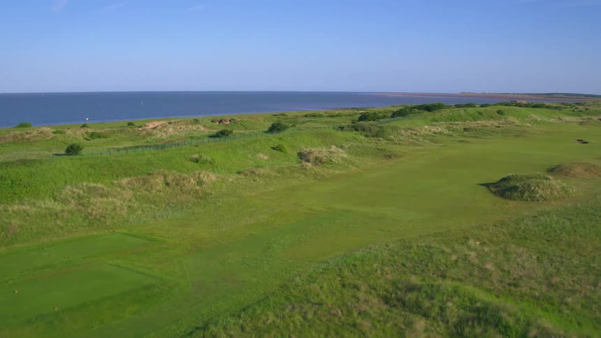 Green grass and hills on a shoreline cliff