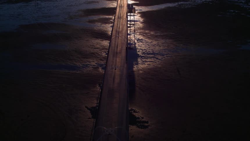 An overhead view of a couple roads that crisscross and it is night time