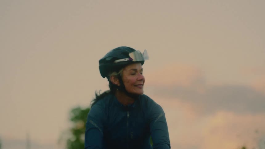 Female cyclist cycling outdoors with happy expression