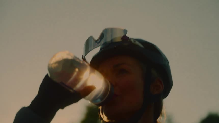 Female cyclist drinking water
